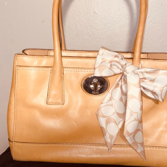 Coach Handbags - Elegant Tan Handbag with Bow Accent
